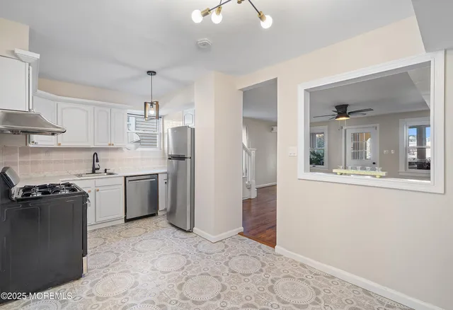 a kitchen with a sink cabinets and stainless steel appliances