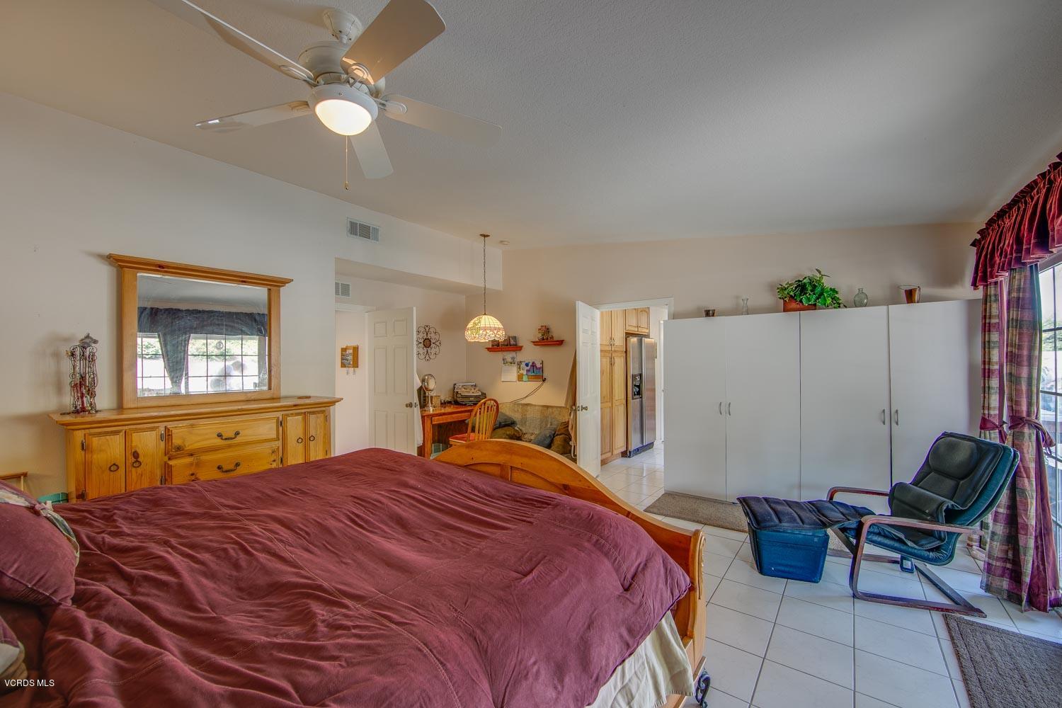 4295 Springfield Street Simi Valley, CA 93063 - Photo 13 of 40 a bedroom with a bed and a chandelier
