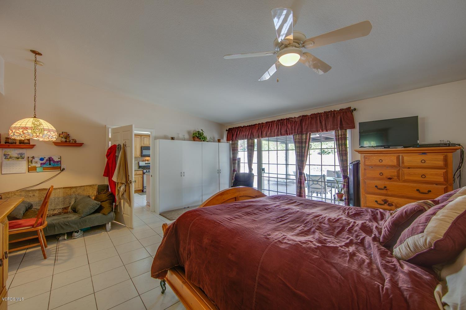 4295 Springfield Street Simi Valley, CA 93063 - Photo 14 of 40 a bedroom with a bed and a chandelier