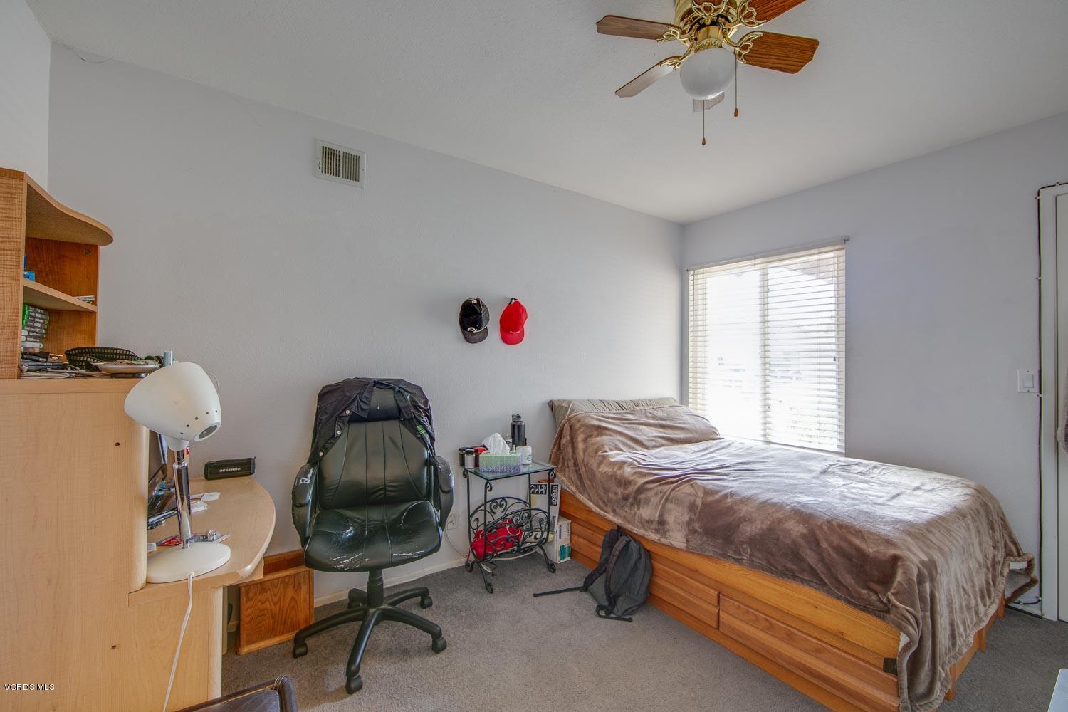 4295 Springfield Street Simi Valley, CA 93063 - Photo 21 of 40 a bedroom with a bed and a chandelier
