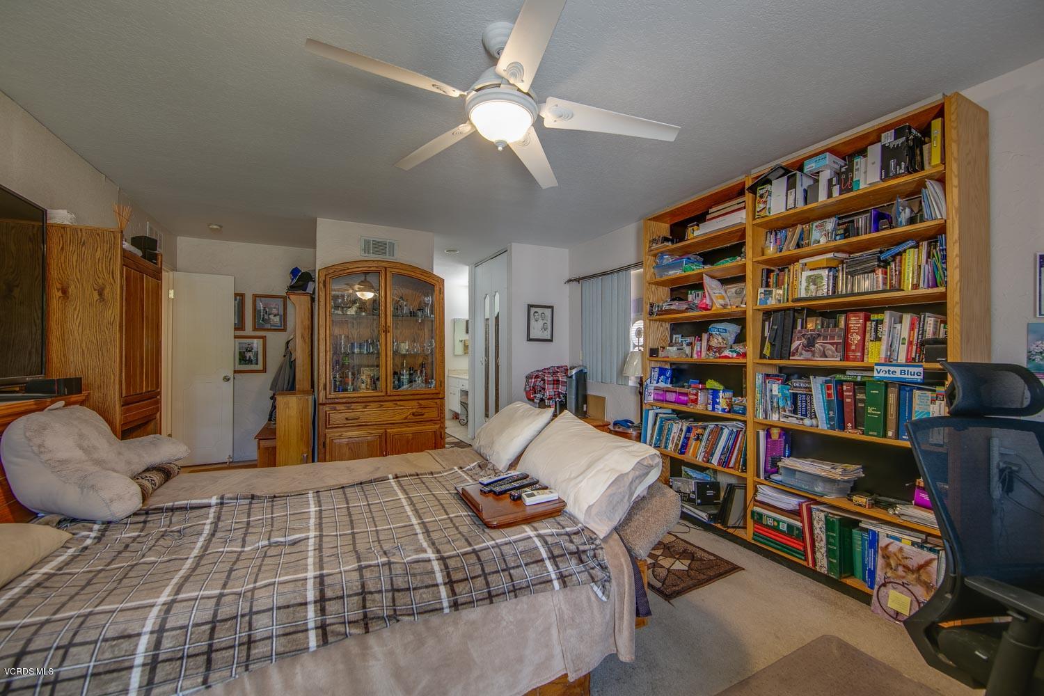4295 Springfield Street Simi Valley, CA 93063 - Photo 24 of 40 a bedroom with a large bed and a book shelf
