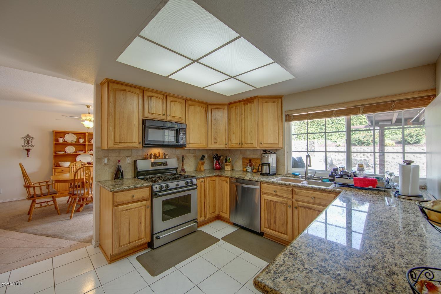 4295 Springfield Street Simi Valley, CA 93063 - Photo 10 of 40 a kitchen with a sink stove and cabinets