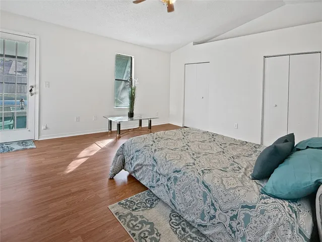 a bedroom with a bed and wooden floor