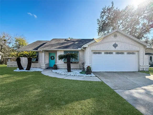 a front view of a house with a garden and yard