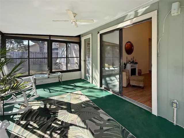 a living room with a bed furniture and a large window