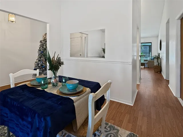 a dining room with furniture and wooden floor