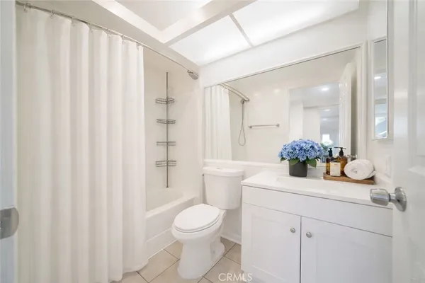 a bathroom with a sink a toilet and shower curtain