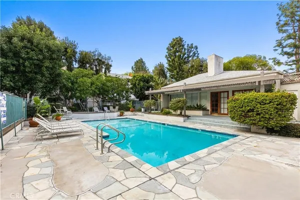a view of house with swimming pool outdoor seating