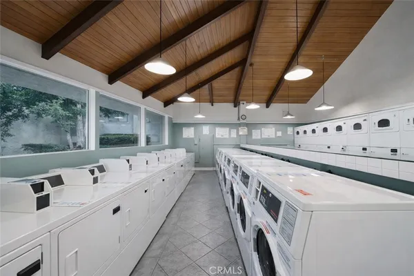 a large white kitchen with a large window