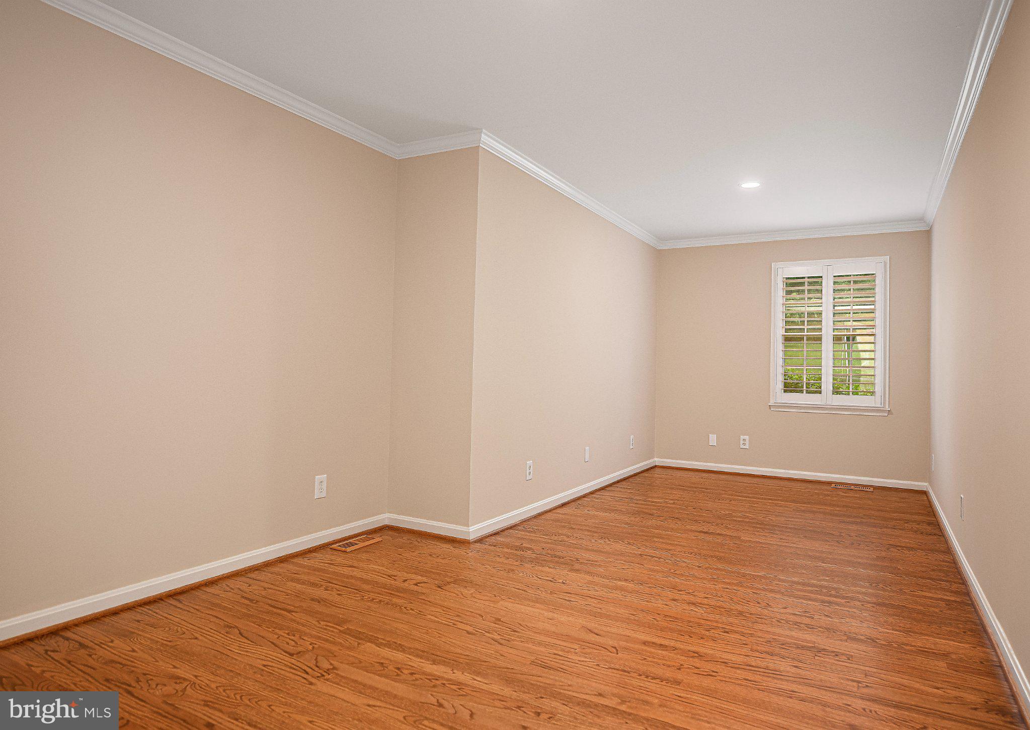 14300 Carroll Ridge Court Baldwin, MD 21013 - Photo 32 of 73 a view of an empty room with wooden floor and a window