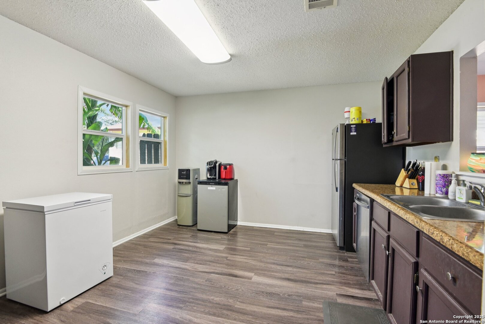113 Friendswood Path Universal City, TX 78148 - Photo 16 of 40 a kitchen with a sink cabinets and wooden floor