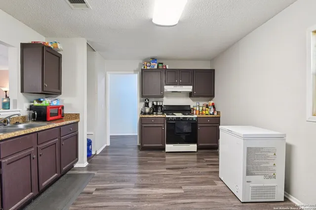 a kitchen with stainless steel appliances granite countertop a stove and a refrigerator