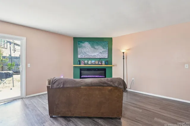 a living room with furniture and a floor to ceiling window