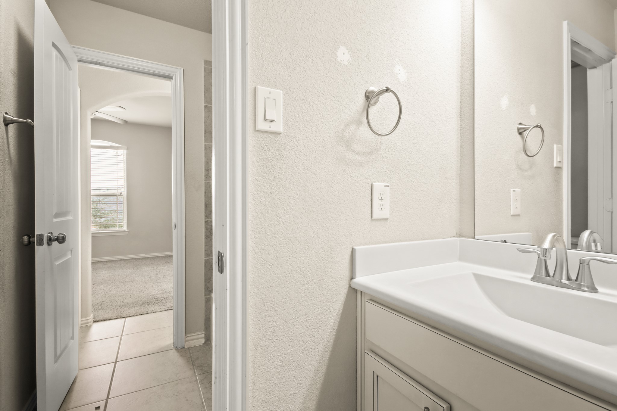 23122 Biddle Drive Porter, TX 77365 - Photo 15 of 26 Upstairs bedrooms connected by a convenient Jack and Jill bathroom, offering privacy and shared accessibility. Each bedroom provides ample space, natural light, and cozy comfort