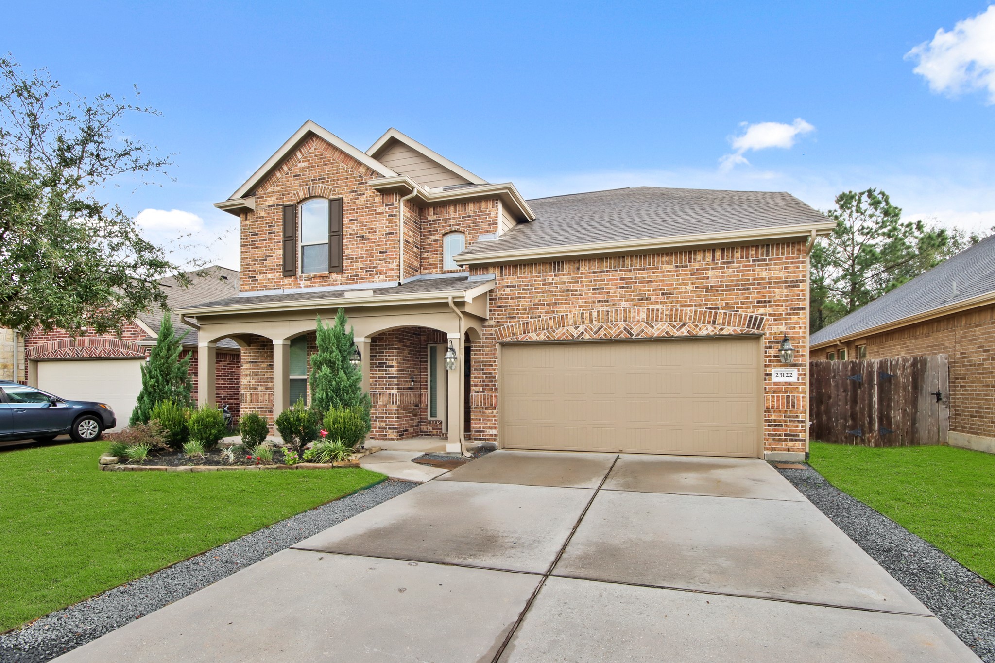 23122 Biddle Drive Porter, TX 77365 - Photo 2 of 26 Double-wide driveway with an attached garage and well-maintained landscaping.