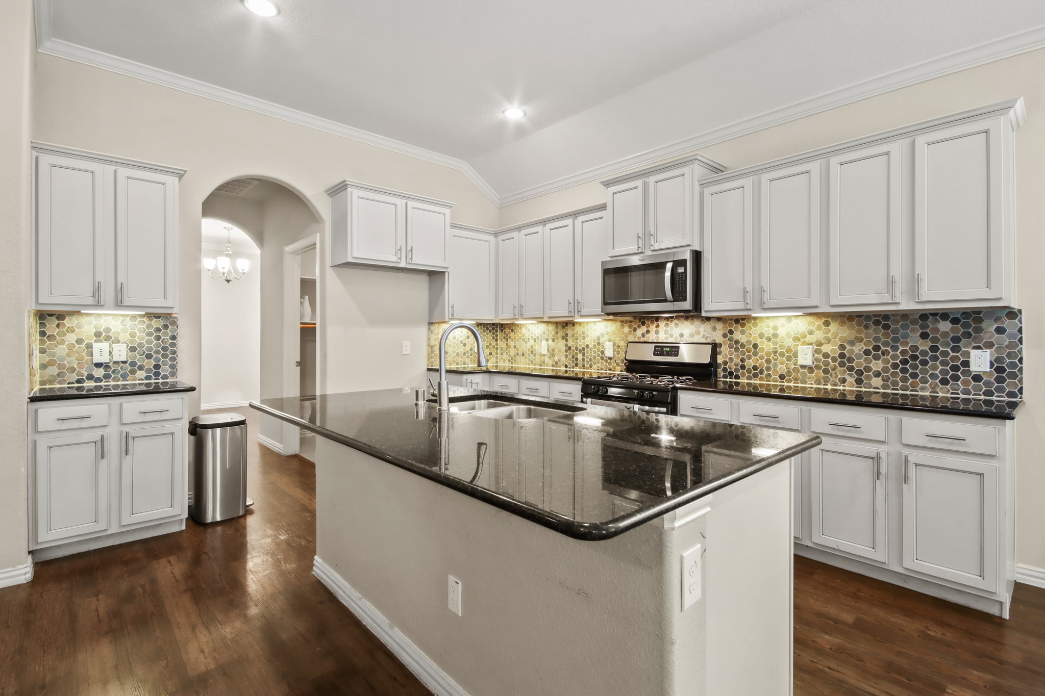 23122 Biddle Drive Porter, TX 77365 - Photo 4 of 26 Beautiful open-style kitchen featuring granite island countertops, stainless steel appliances, ample cabinetry, and generous pantry space.