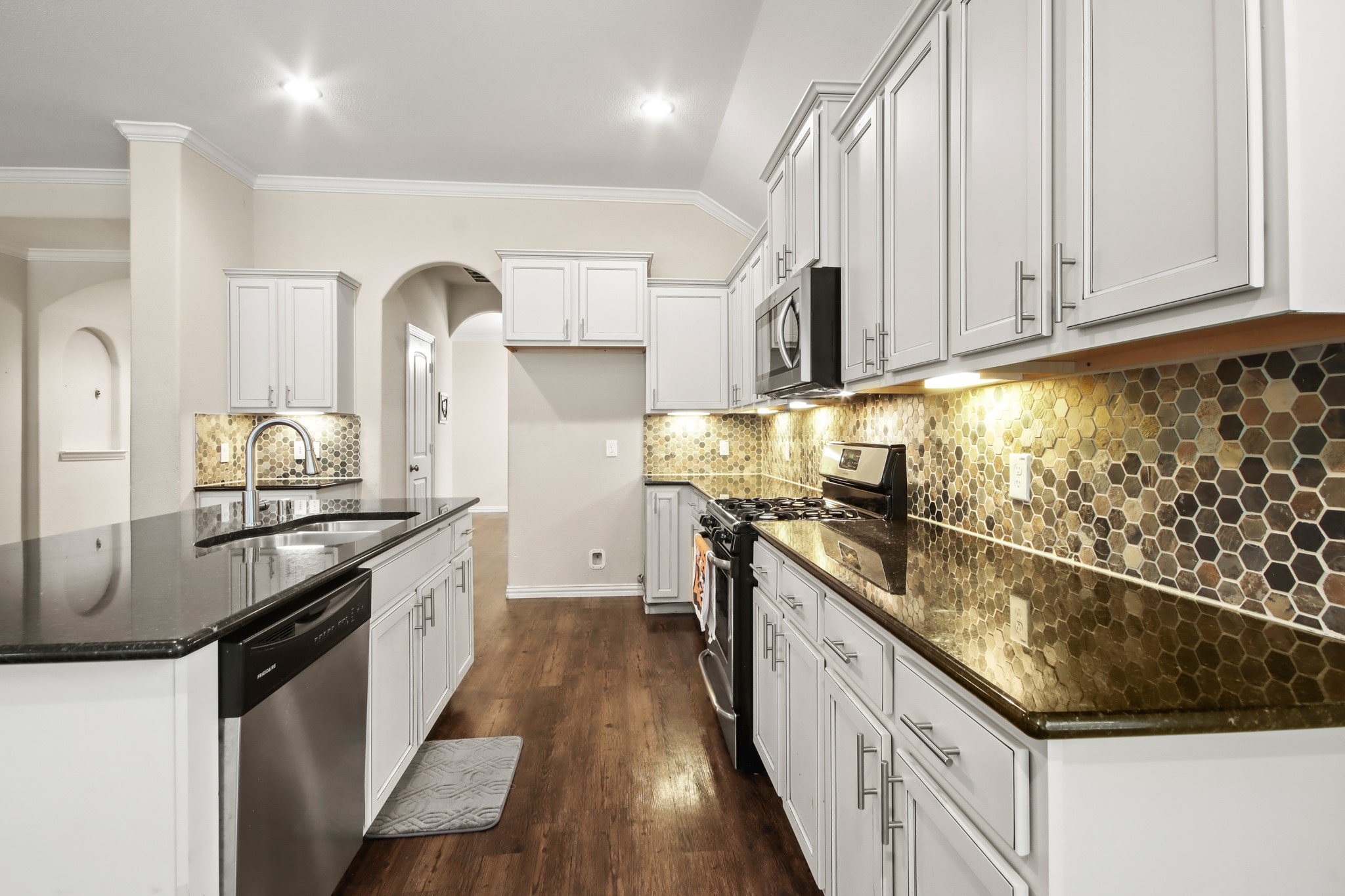 23122 Biddle Drive Porter, TX 77365 - Photo 5 of 26 Beautiful open-style kitchen featuring granite island countertops, stainless steel appliances, ample cabinetry, and generous pantry space.