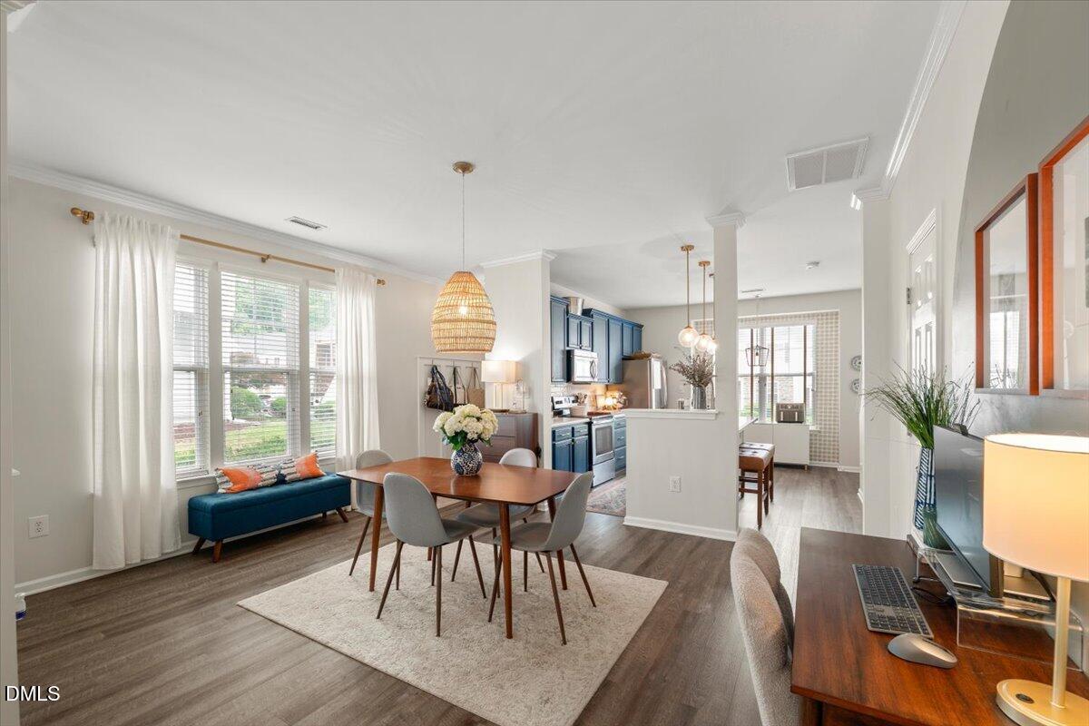 8449 Central Drive Raleigh, NC 27613 - Photo 14 of 38 a dining room with wooden floor and windows