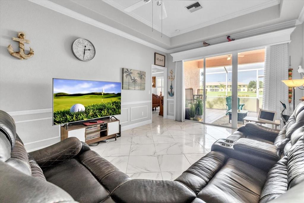 1260 Rio De Janeiro Avenue, Unit 102 Punta Gorda, FL 33983 - Photo 6 of 46 a living room with furniture and a flat screen tv