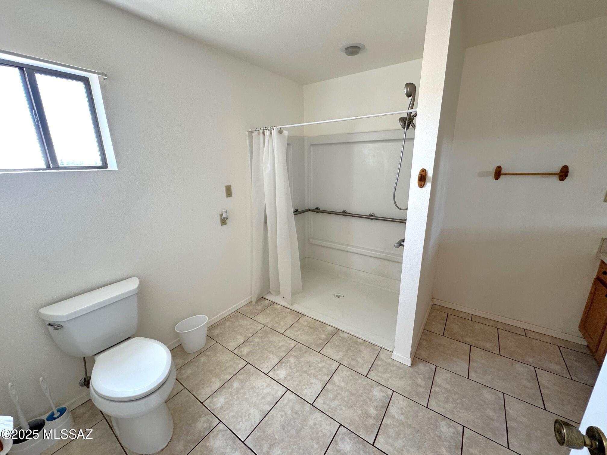 13384 South Cottonwood Road Pearce, AZ 85625 - Photo 18 of 46 a bathroom with a toilet and a shower