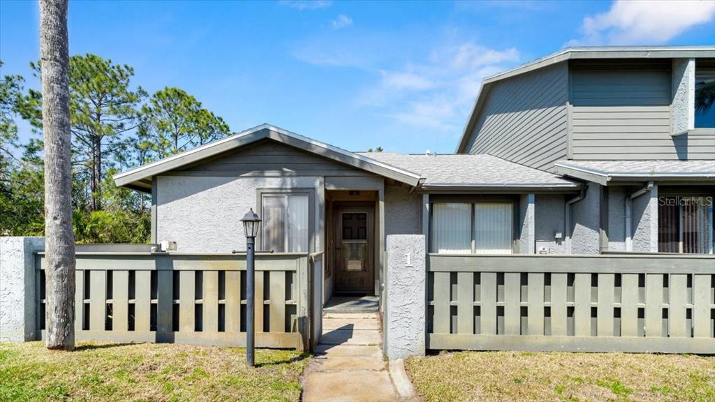 160 Limewood Place, Unit 1 Ormond Beach, FL 32174 - Photo 1 of 1 a view of a house with wooden deck and furniture