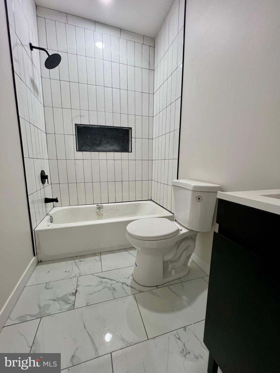 32 South 62nd Street, Unit 2 Philadelphia, PA 19139 - Photo 11 of 15 a bathroom with a sink a toilet and a bathtub