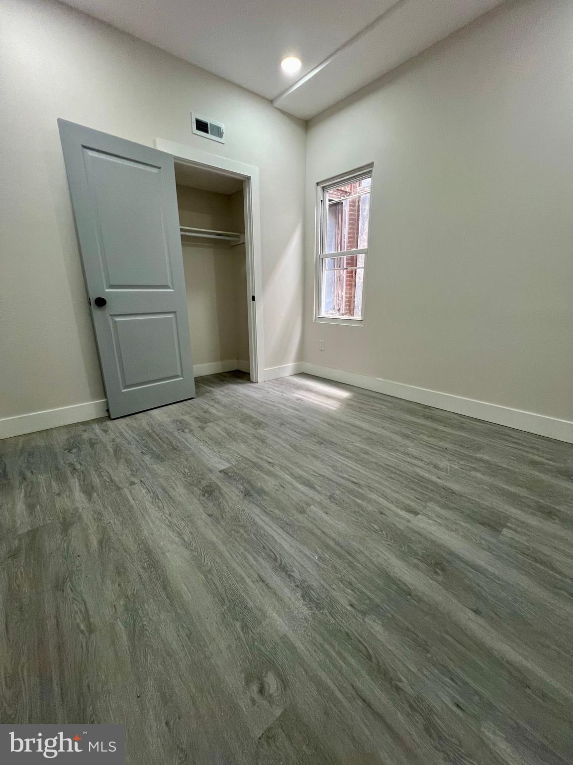 32 South 62nd Street, Unit 2 Philadelphia, PA 19139 - Photo 13 of 15 an empty room with wooden floor and windows