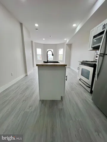 a view of kitchen with cabinets and wooden floor