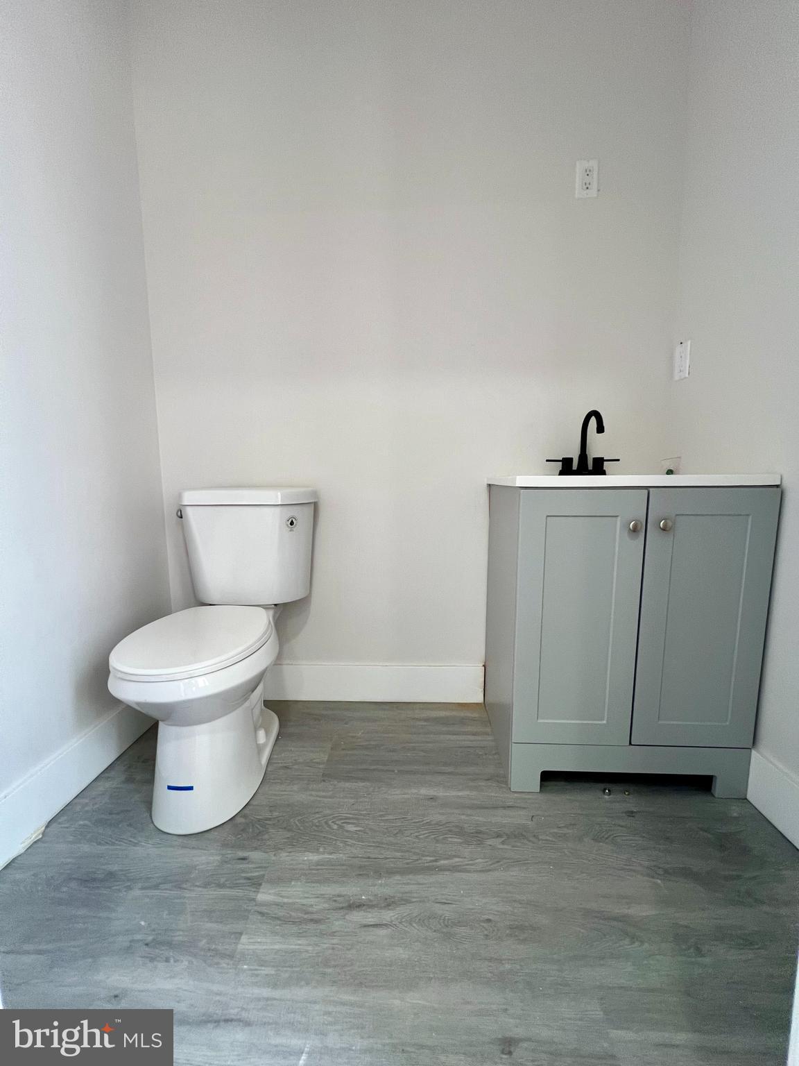 32 South 62nd Street, Unit 2 Philadelphia, PA 19139 - Photo 7 of 15 a white toilet sitting next to a white cabinet