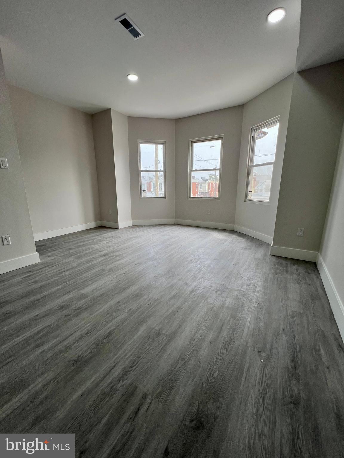 32 South 62nd Street, Unit 2 Philadelphia, PA 19139 - Photo 9 of 15 an empty room with wooden floor and windows