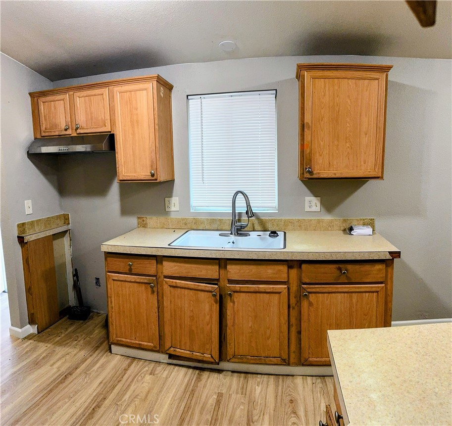3181 Springe Street Nice, CA 95464 - Photo 2 of 14 a kitchen with a sink cabinets and a wooden floor