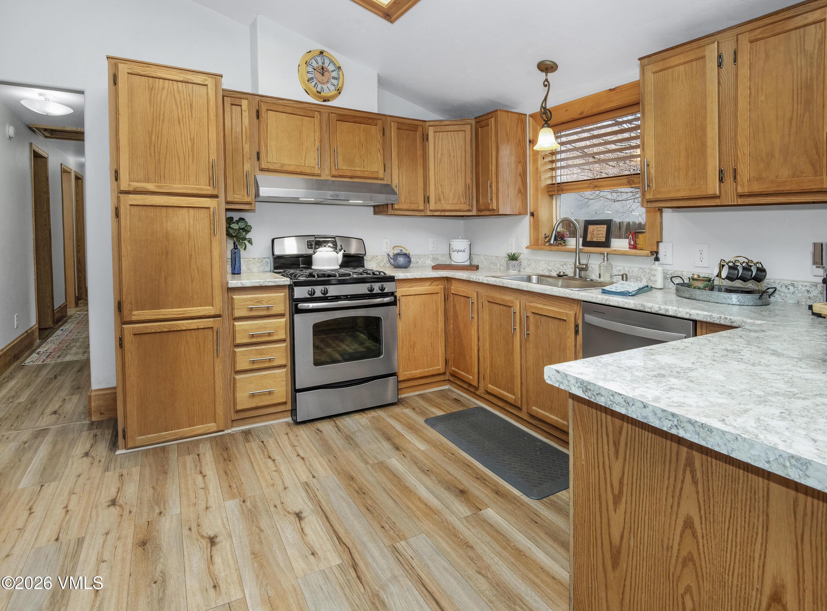 430 Porphyry Road Gypsum, CO 81637 - Photo 2 of 42 a kitchen with a sink a refrigerator and cabinets