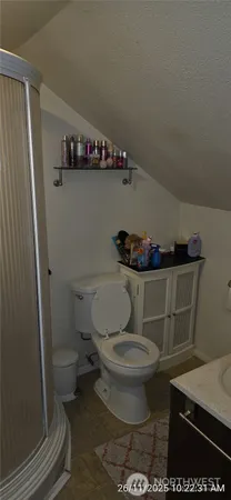a bathroom with a toilet and a mirror