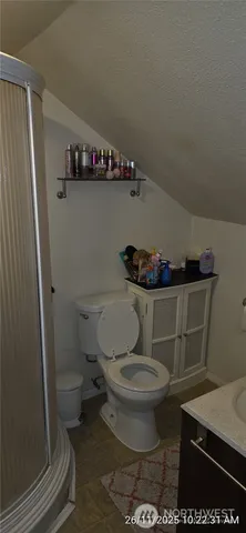 a bathroom with a toilet and a mirror
