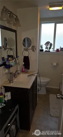 a bathroom with a sink toilet and mirror