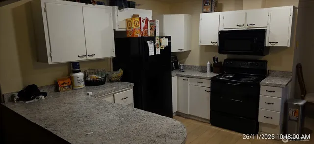 a kitchen with a refrigerator and a stove top oven