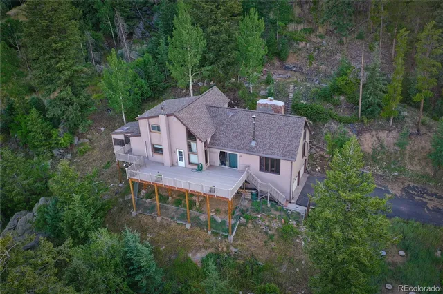 an aerial view of a house with yard and outdoor seating