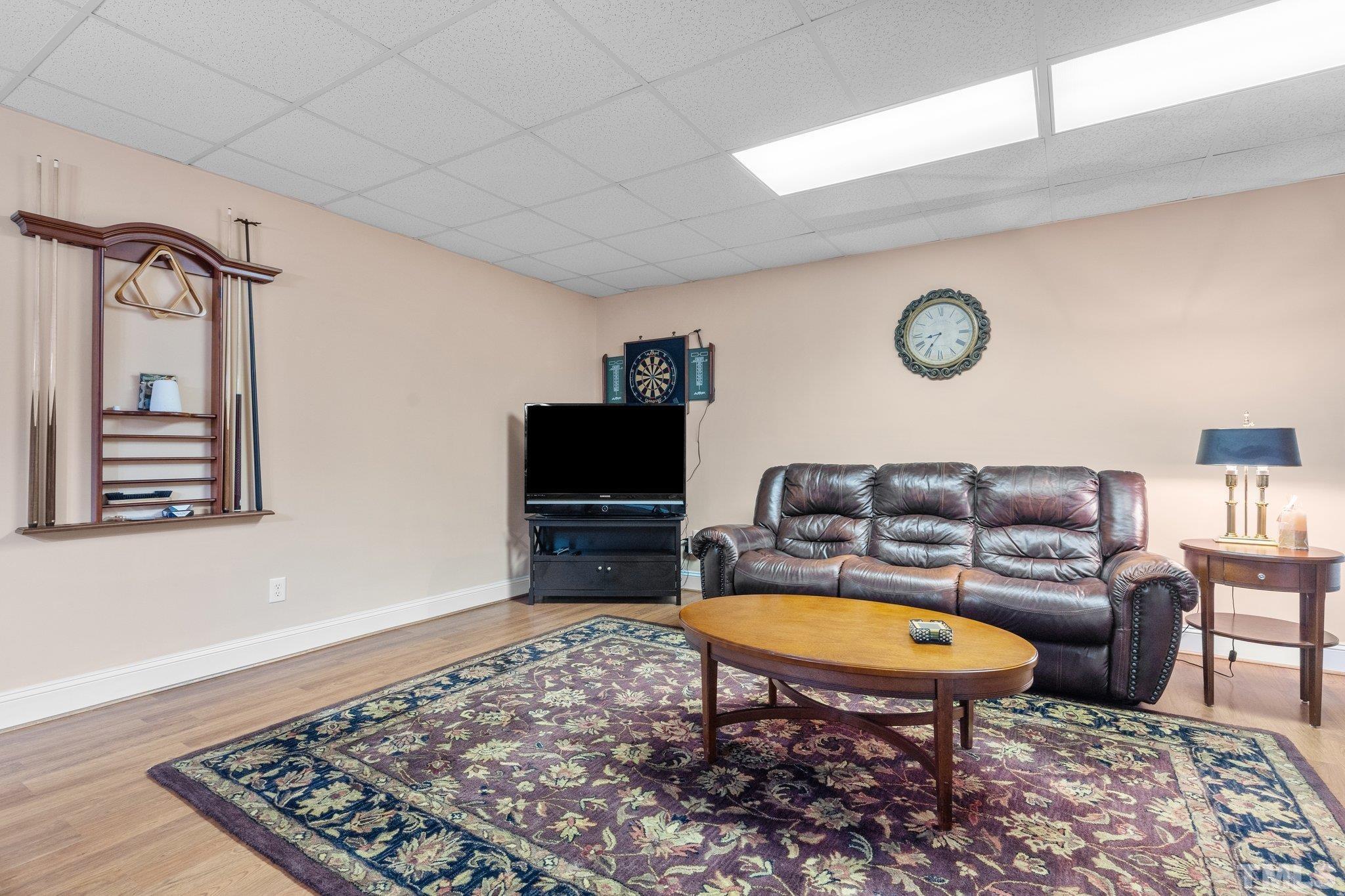 1145 Cash Road Creedmoor, NC 27522 - Photo 43 of 58 a living room with couch a rug and a flat screen tv