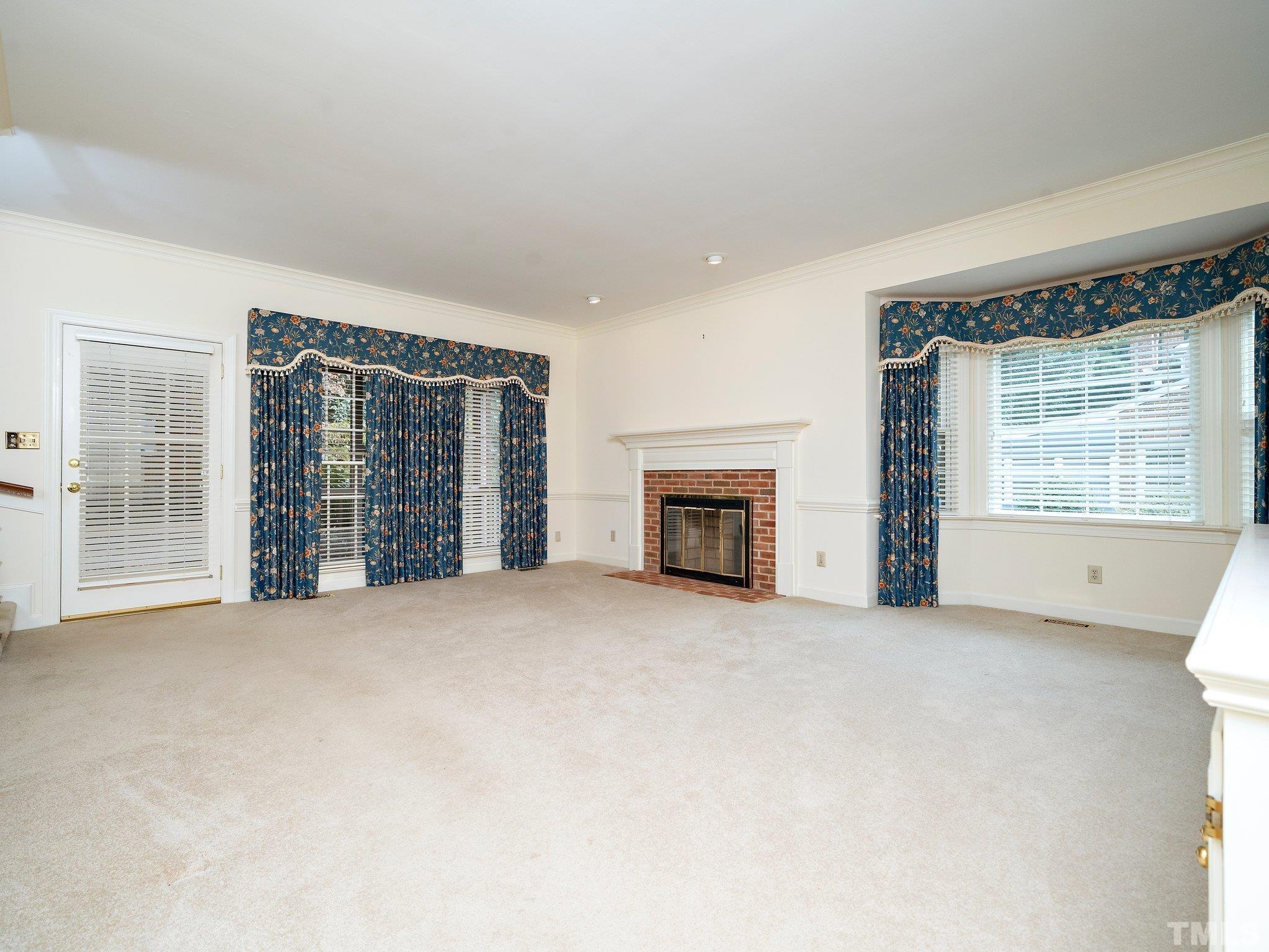 417 Weathergreen Drive Raleigh, NC 27615 - Photo 12 of 37 an empty room with furniture and a fireplace