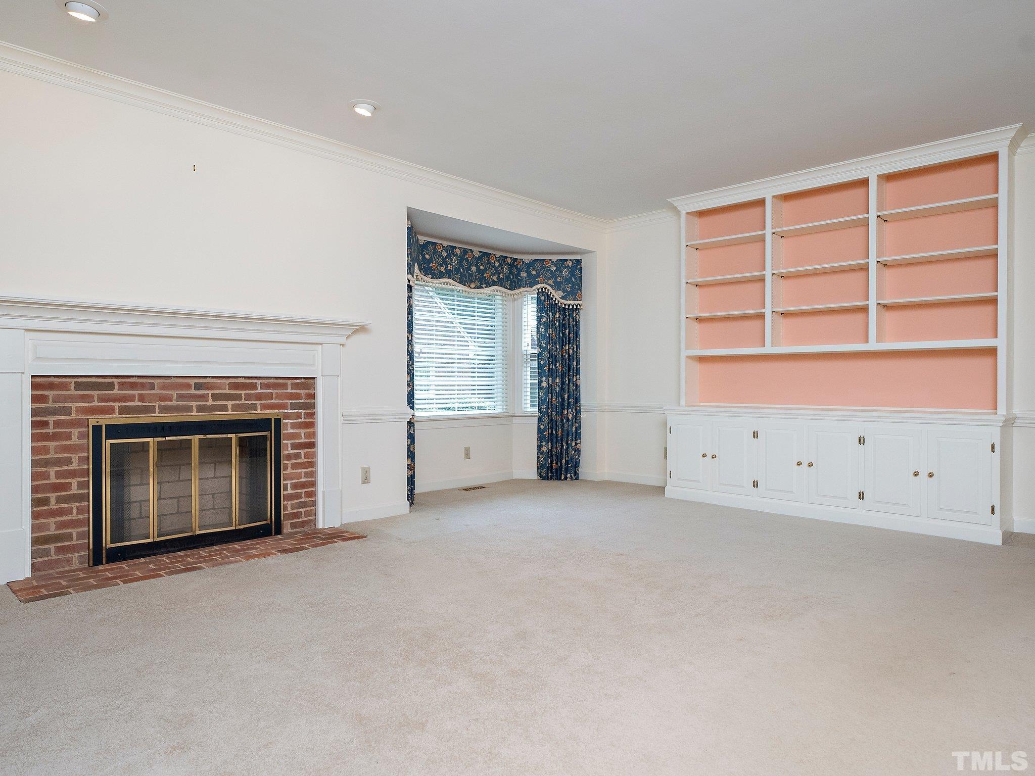 417 Weathergreen Drive Raleigh, NC 27615 - Photo 15 of 37 an empty room with a fireplace and window