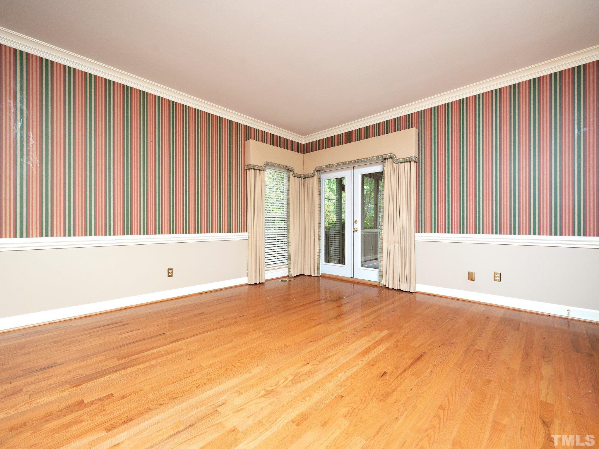 417 Weathergreen Drive Raleigh, NC 27615 - Photo 18 of 37 a view of an empty room with wooden floor and a window