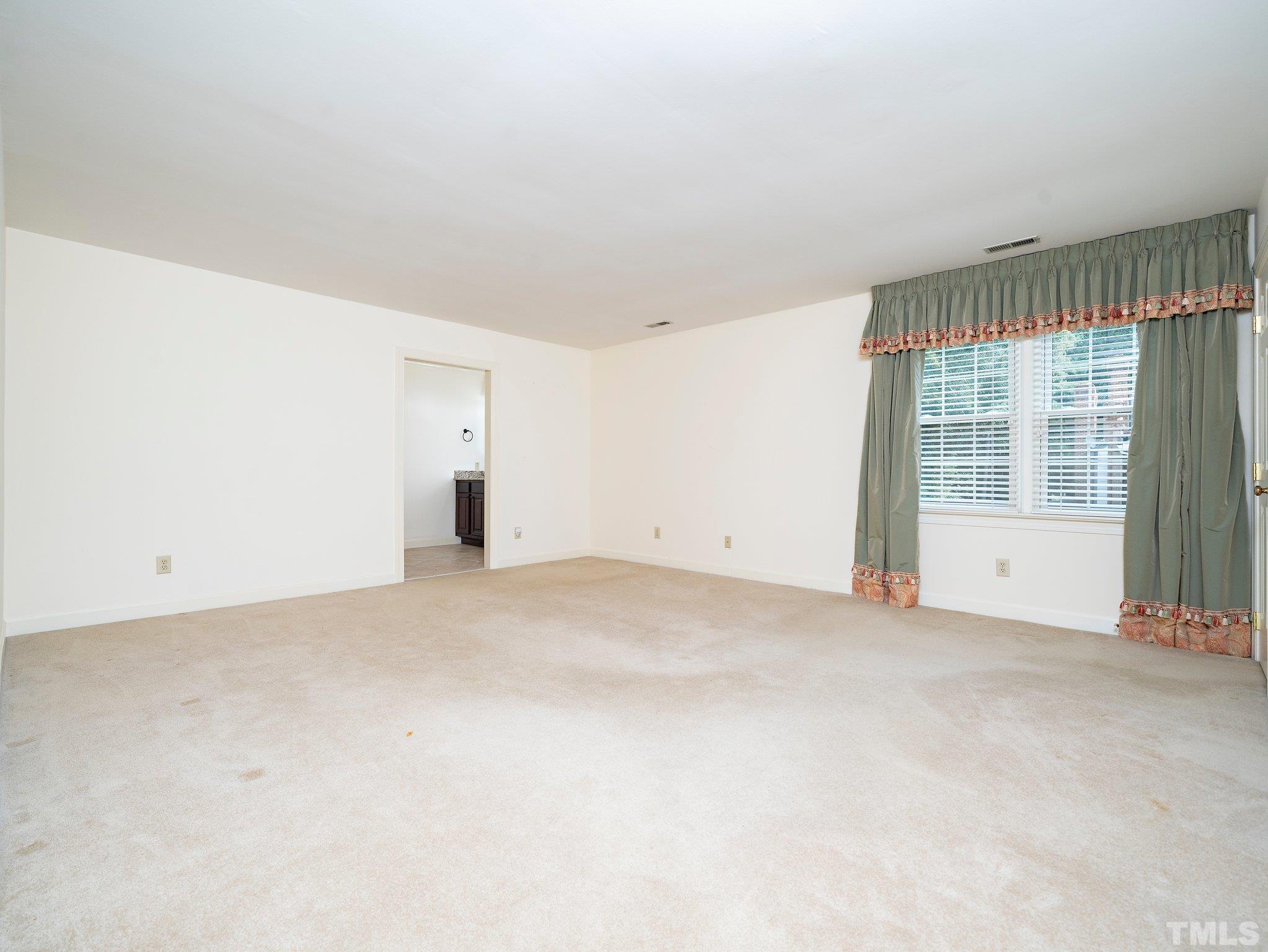 417 Weathergreen Drive Raleigh, NC 27615 - Photo 24 of 37 an empty room with an empty space and window
