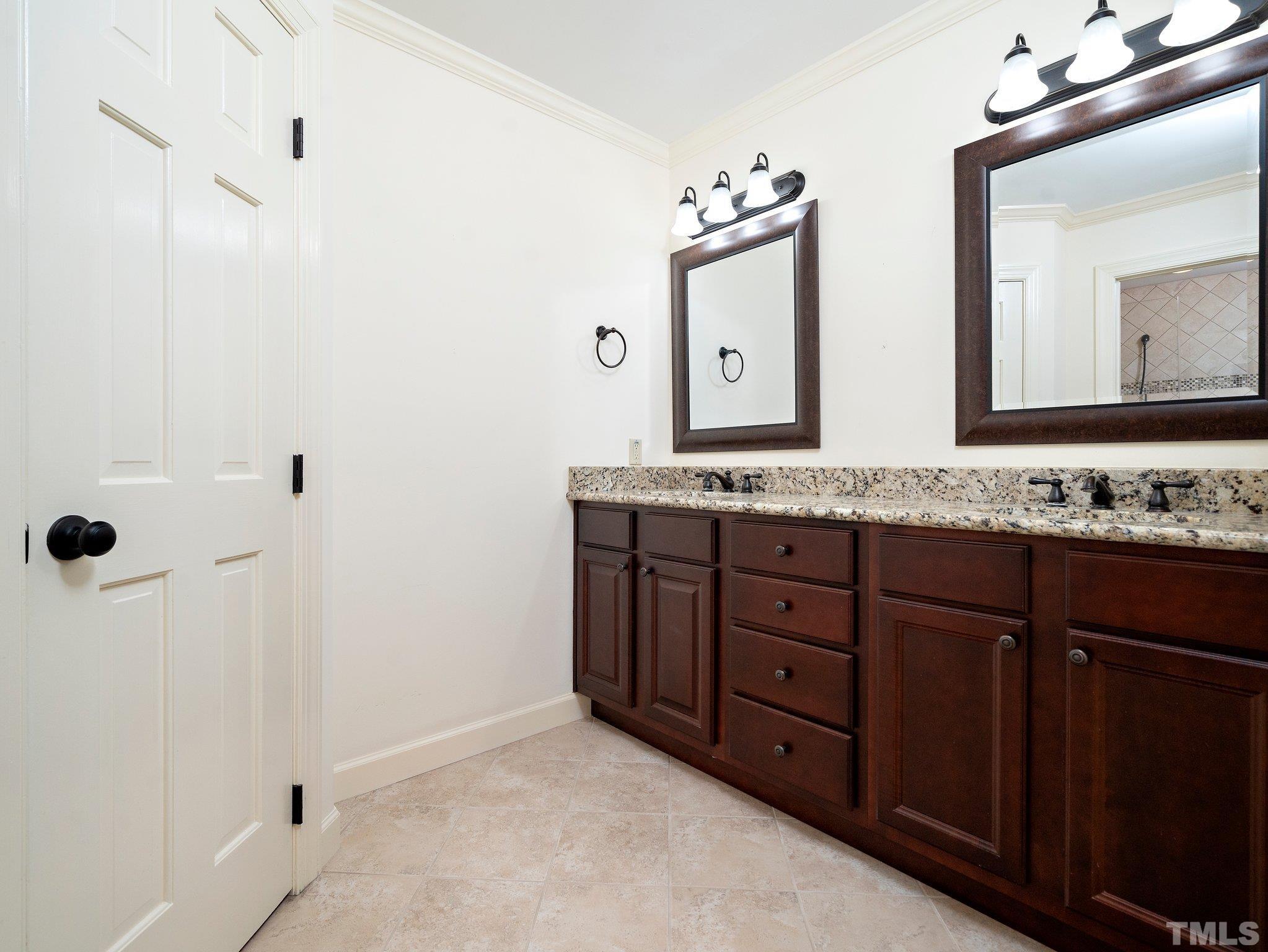 417 Weathergreen Drive Raleigh, NC 27615 - Photo 26 of 37 a bathroom with a granite countertop sink and a mirror