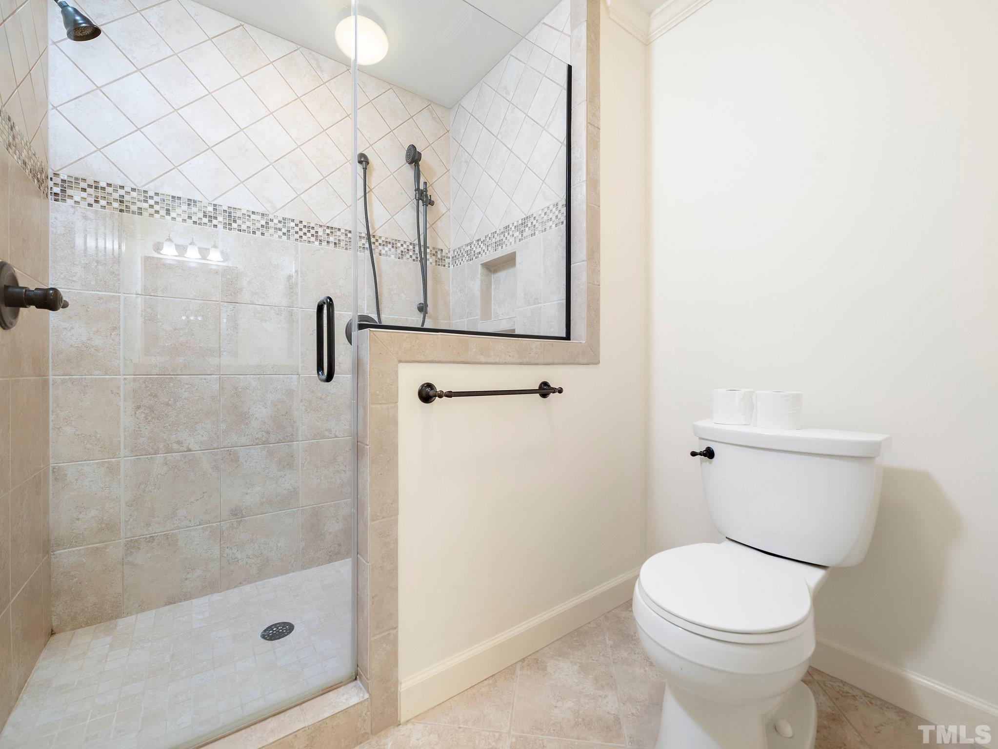 417 Weathergreen Drive Raleigh, NC 27615 - Photo 27 of 37 a bathroom with a toilet and a shower