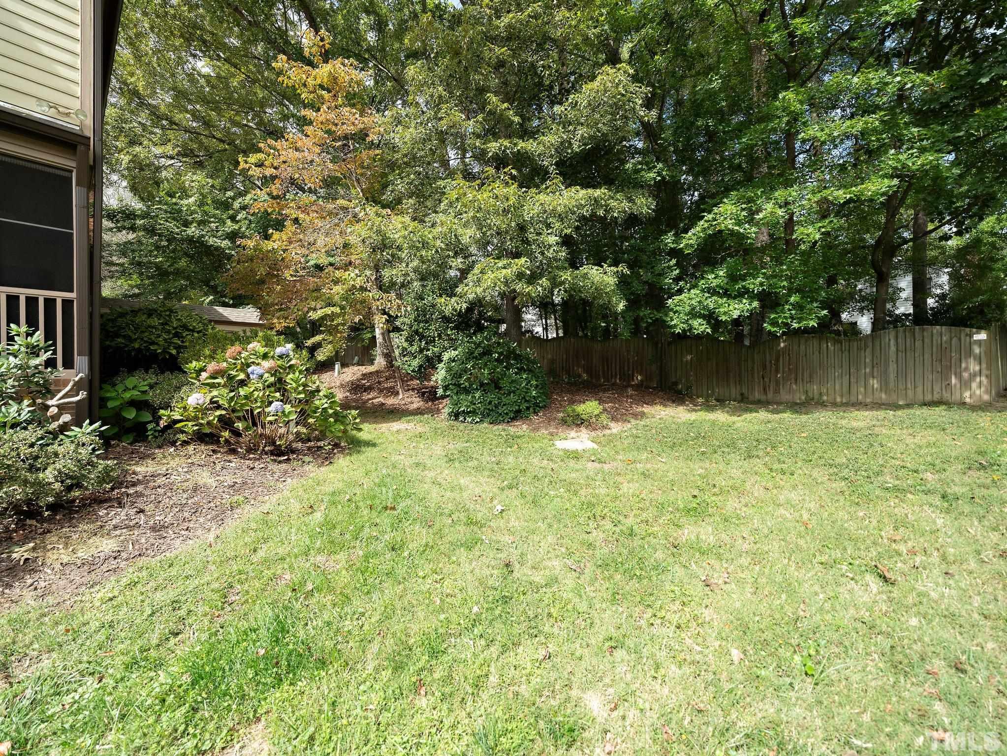 417 Weathergreen Drive Raleigh, NC 27615 - Photo 36 of 37 a backyard of a house with lots of green space