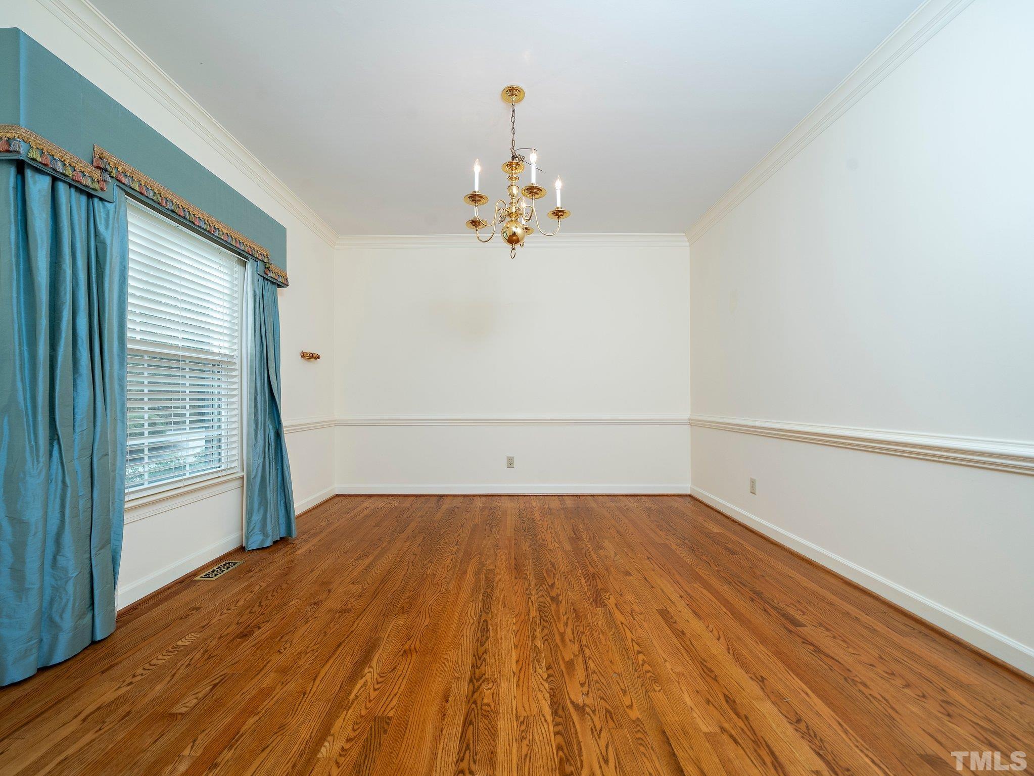 417 Weathergreen Drive Raleigh, NC 27615 - Photo 7 of 37 a view of empty room with wooden floor