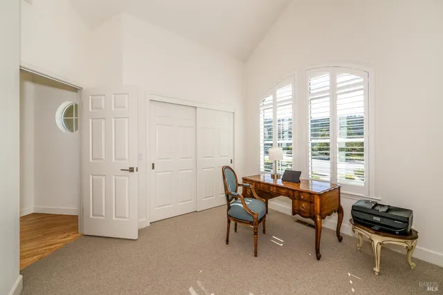 a view of a workspace with furniture and a window