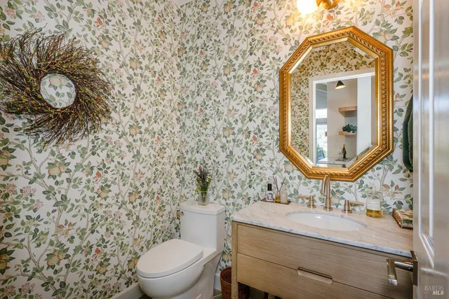 a bathroom with a toilet a sink and mirror