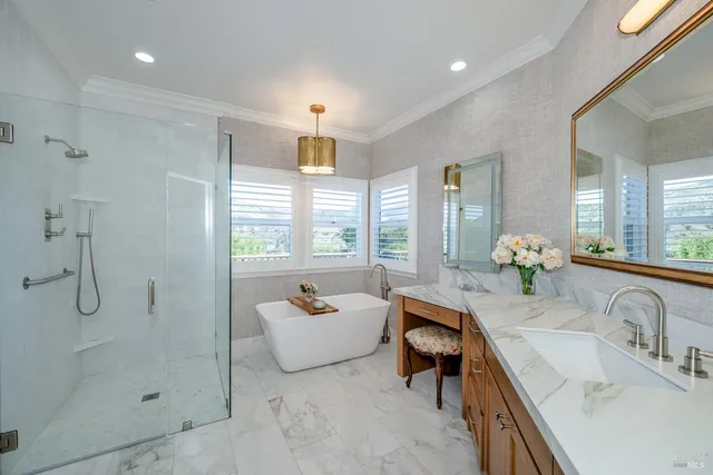 a spacious bathroom with a shower sink and mirror
