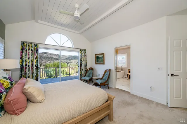 a bed room with a bed and a large window